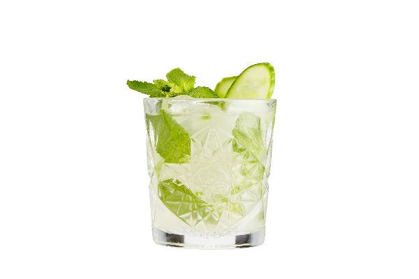 Drink med navnet “Summer Grace” serveret i et glas med lyserød farve og pyntet med frisk frugt – en sommerlig og elegant cocktail.